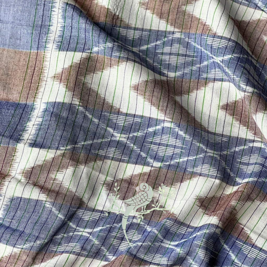 Close-up of patterned fabric with blue, brown, and white colors.